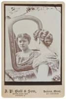 Woman Looking at Herself in a Mirror.